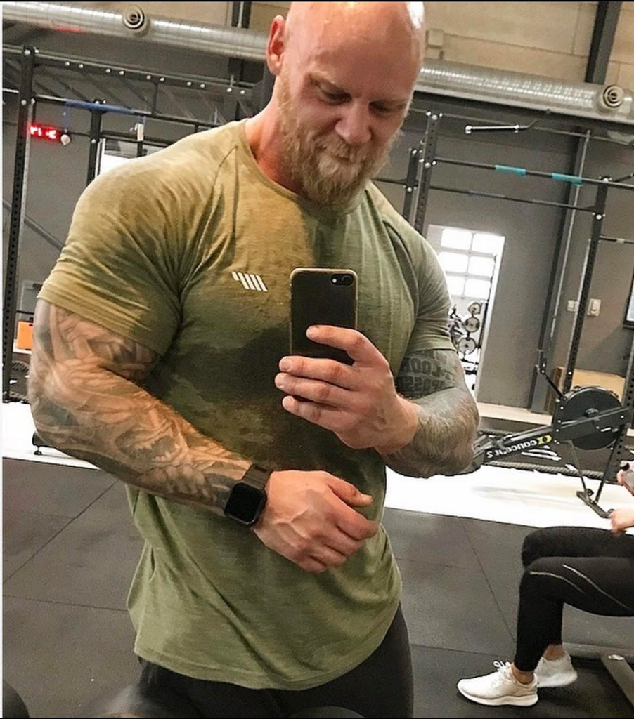 Coach in an army green t-shirt at the gym.